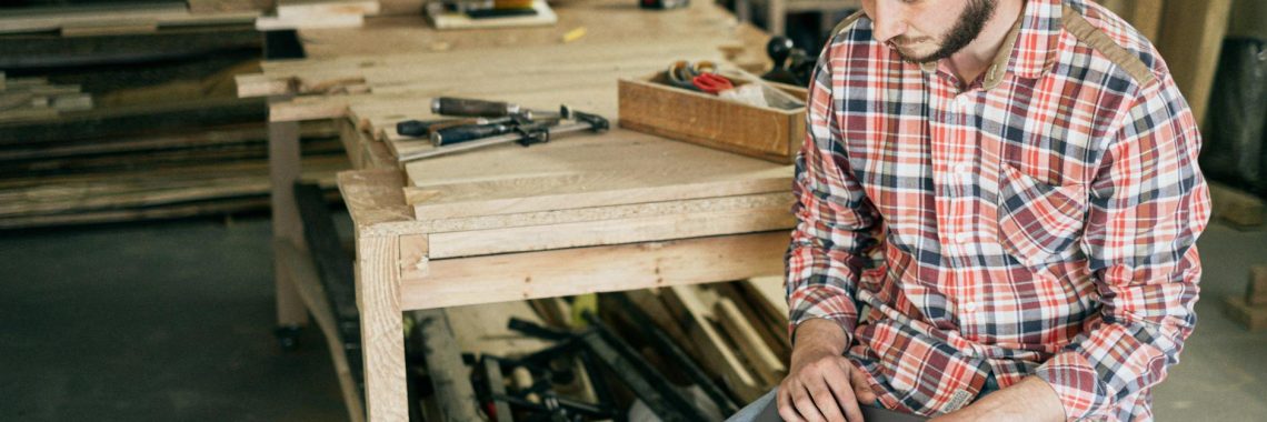 Entrepreneur comparing the best AI tools for small business owners on a laptop to streamline daily operations.