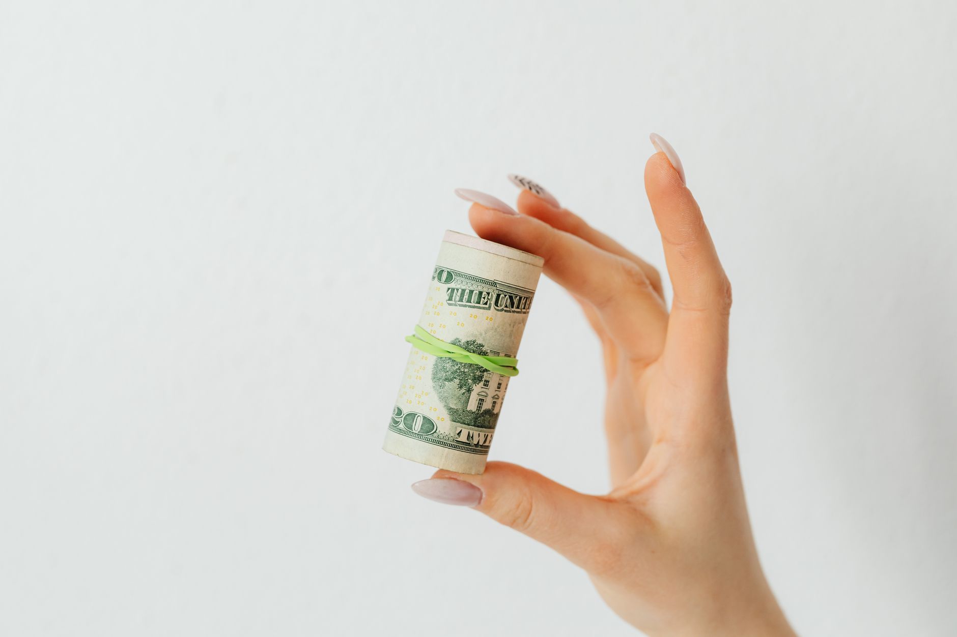 Graphic showing a hand grabbing fast cash with warning signs for risky quick‑money schemes