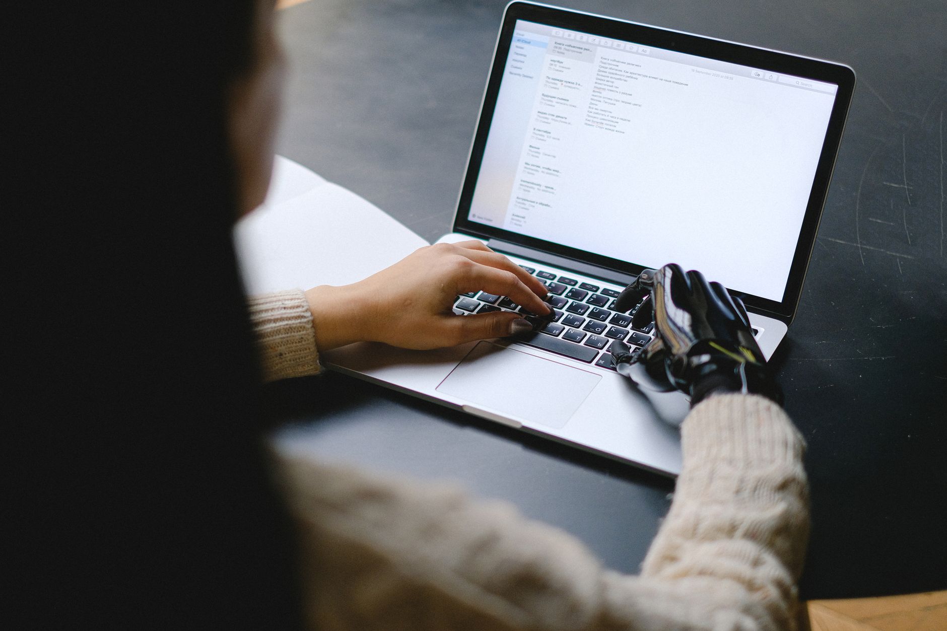 Screenshot of a free AI writing assistant generating an essay on a laptop screen.